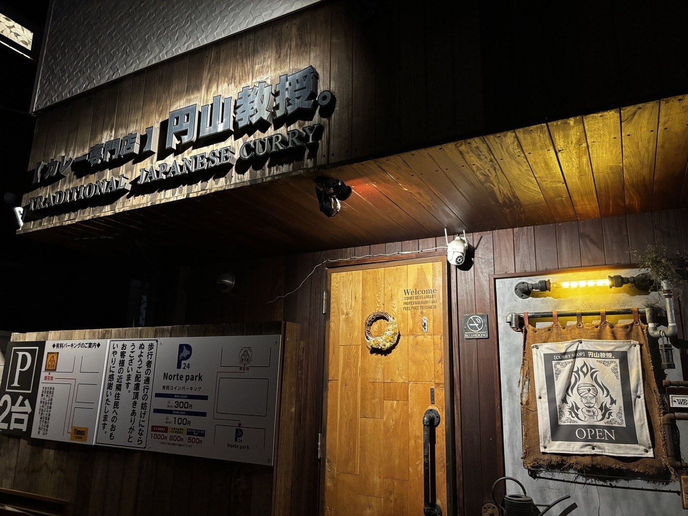円山教授。の外観。木の看板とOPENの暖簾